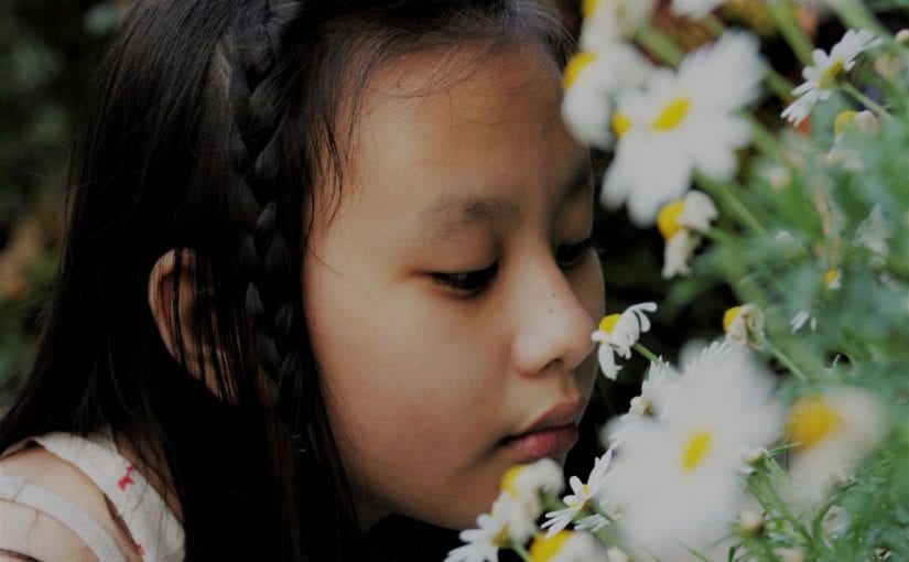 girl smelling flowers