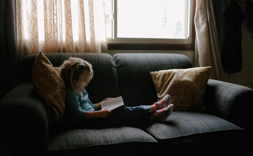 Girl Reading on Couch