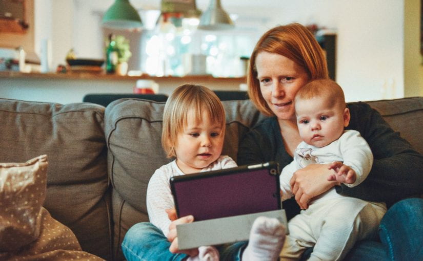 Woman and young children on couch